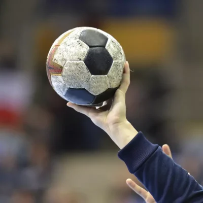 a person holding a soccer ball in their hand.